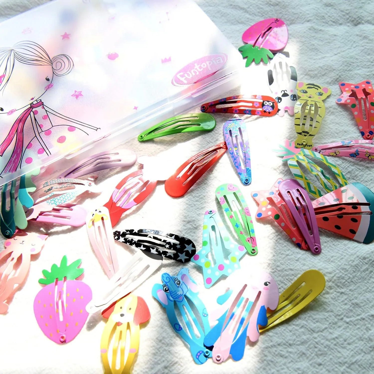 Assortment of 100 candy-coloured metal snap hair clips showing drops, animals, crowns, stars, and fruit shapes.