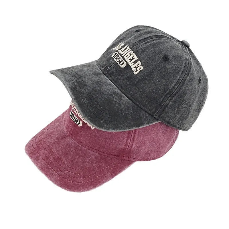 Adult personalised embroidered peaked cap in beige with adjustable strap and distressed lettering.