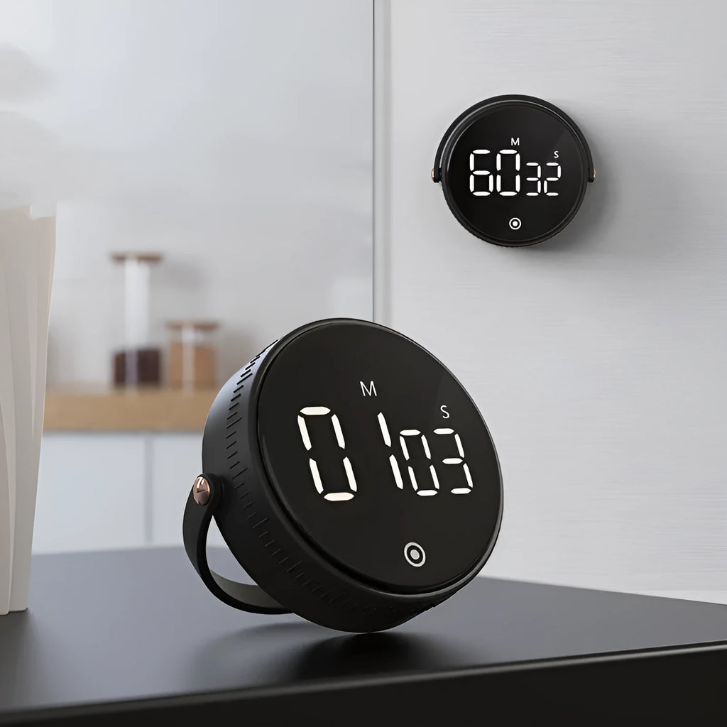 Black digital kitchen timer with rotary dial and LED display showing minutes and seconds