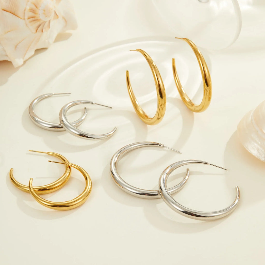 Simple round stainless steel hoop earrings for women in gold and steel colours, available in two sizes.