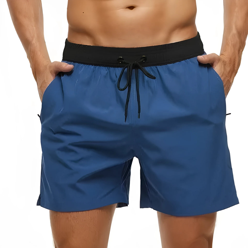 Men's blue fitness shorts with stitched waist headband, drawstring, zipper pocket, and padding for running