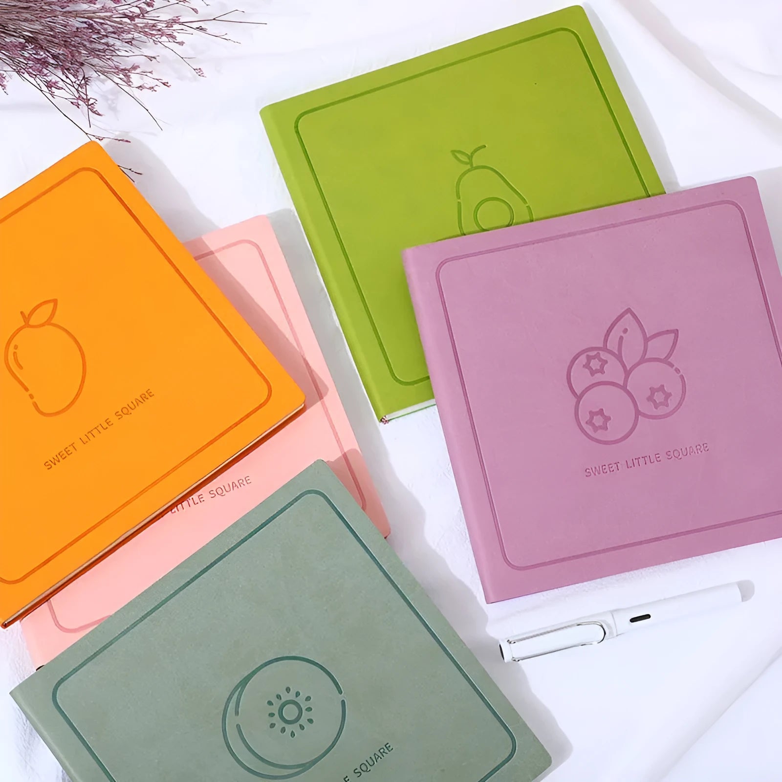 Square faux leather notebook with Daolin paper pages in peach pink, avocado green, and blueberry purple colour options