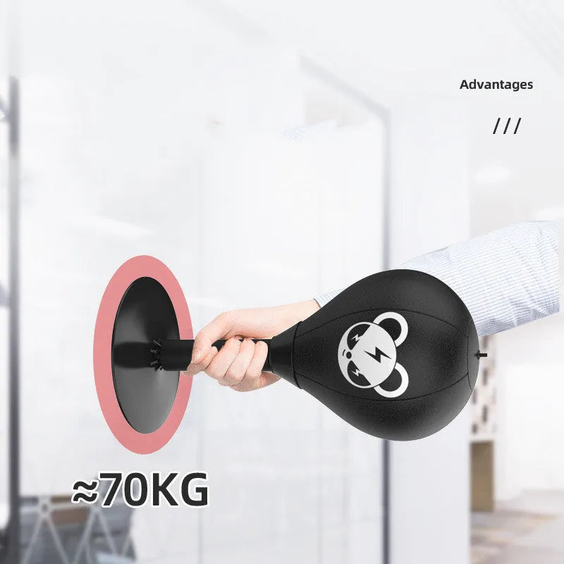 Tabletop boxing speed ball with suction cup base, inflatable PU leather sphere, and pump on a wooden desk.