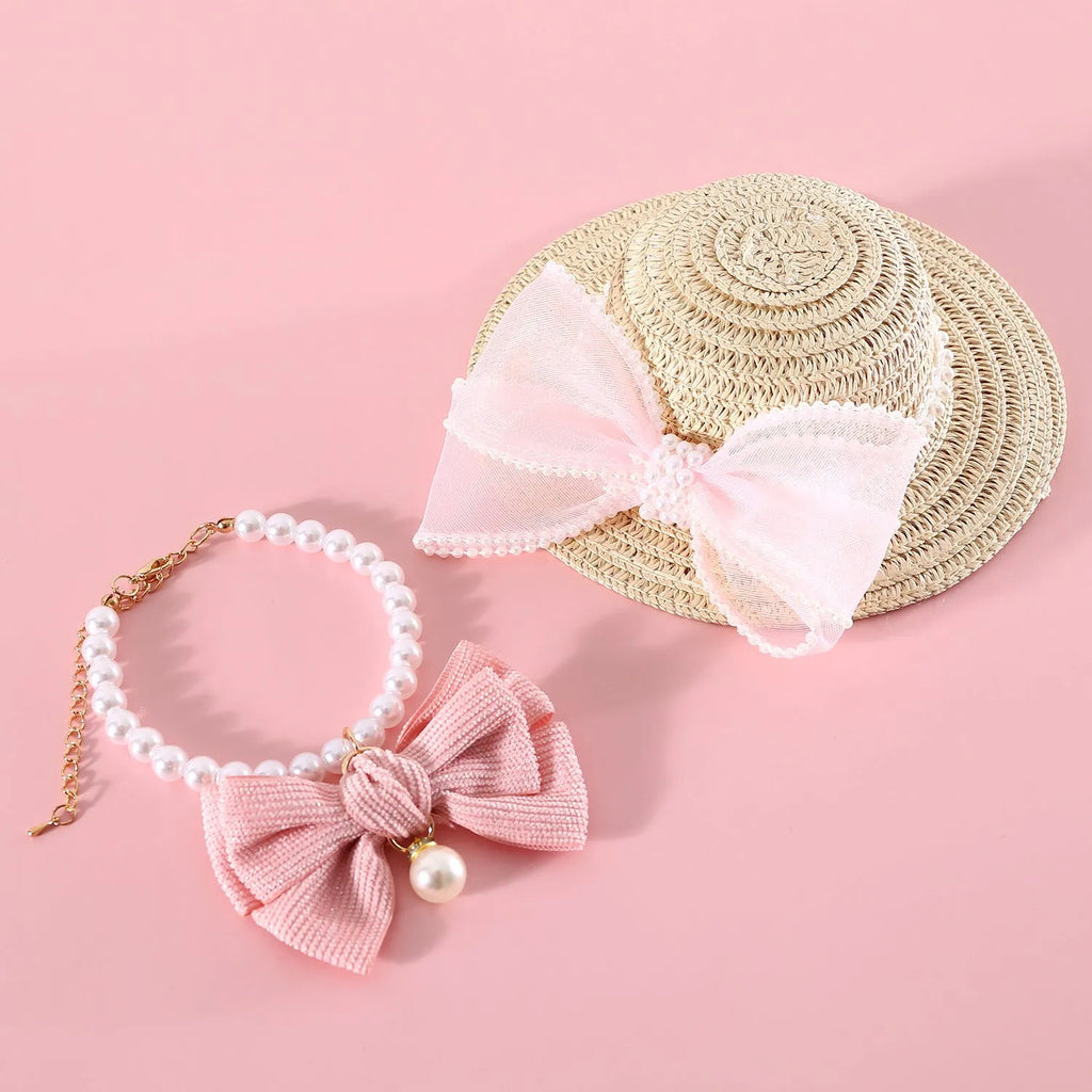 A woven Lafite leaf straw hat for a cat, decorated with a pearl butterfly bow, shown in pink, purple, blue, and white colour options.