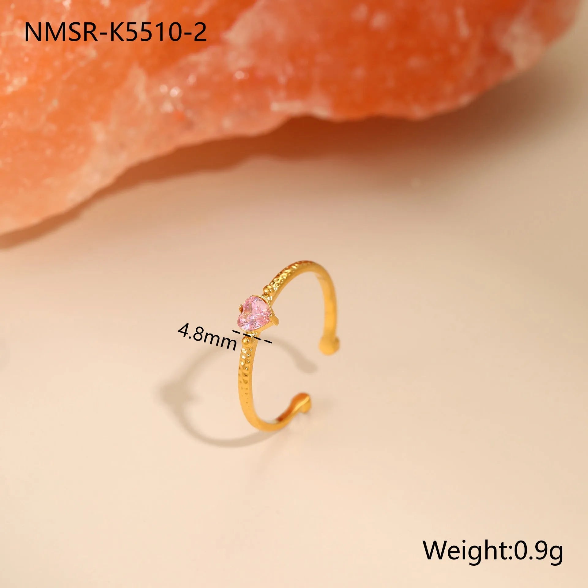 Open ended stainless steel ring with a geometric zircon-inlaid heart in white, pink, or green.