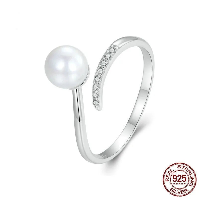 Adjustable sterling silver ring with natural shell pearls showing open loop design