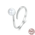 Adjustable sterling silver ring with natural shell pearls showing open loop design