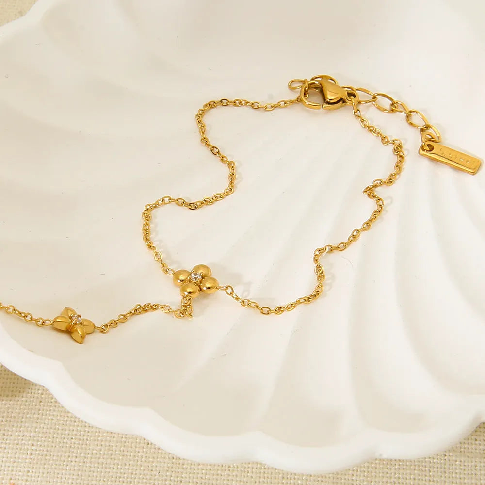 Gold women's stainless steel bracelet with an eight-pointed star and floral geometric design.
