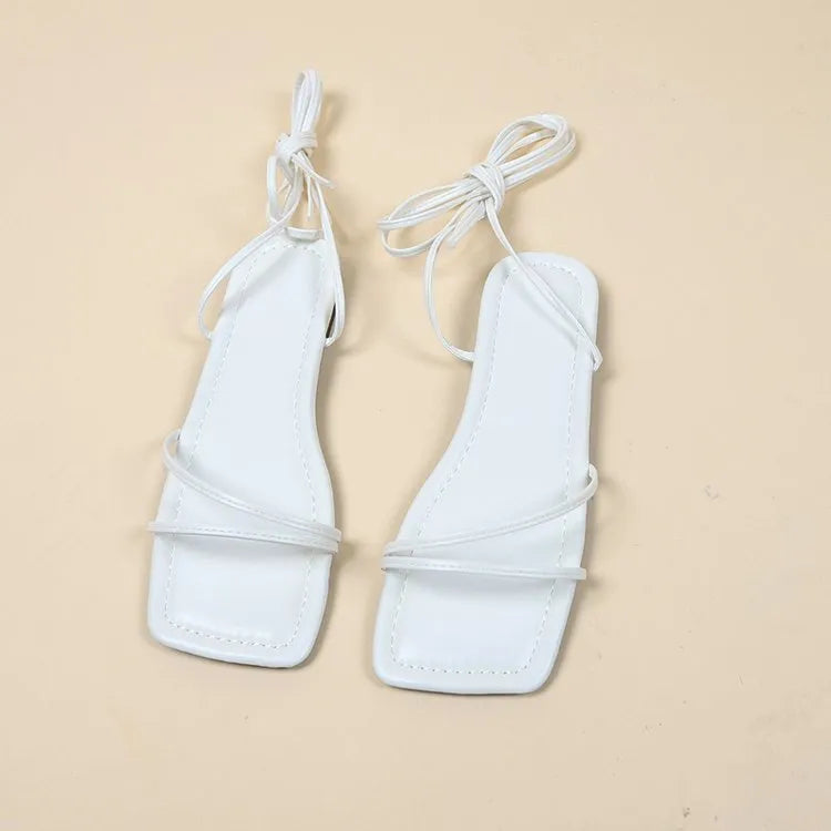 Women's flat sandals with ankle bandage strap in white, featuring a square toe and front lace-up.
