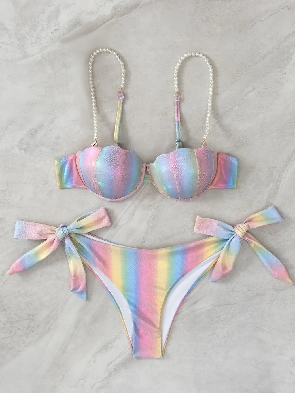 Women's shell rainbow coloured split bikini swimsuit with tied design on a mannequin.