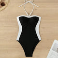 Black and white women's one-piece swimsuit with spaghetti straps and slim fit design