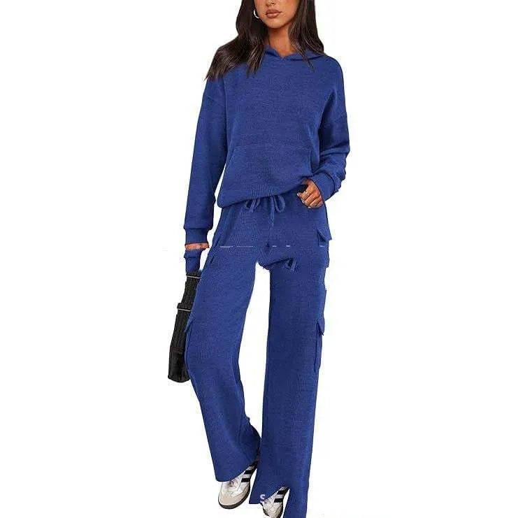 Women's two-piece leisure sports suit in polyester, showing long sleeve top and trousers in a solid colour.