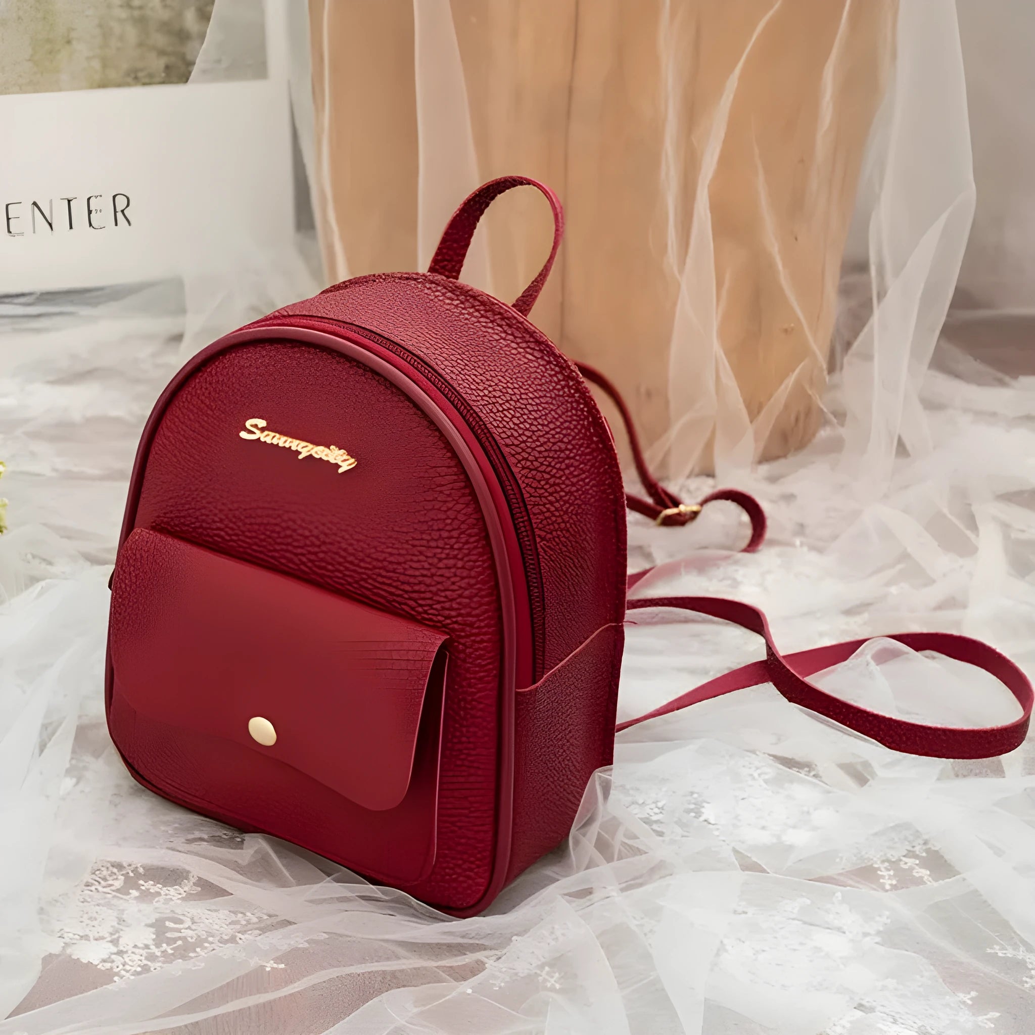 Women's small black PU leather backpack shoulder bag showing front zipper and dimensions