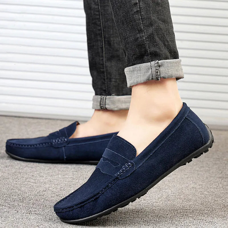Men's suede loafers in black, blue, dark blue, wine red, and yellow colours showing round toe and flat sole
