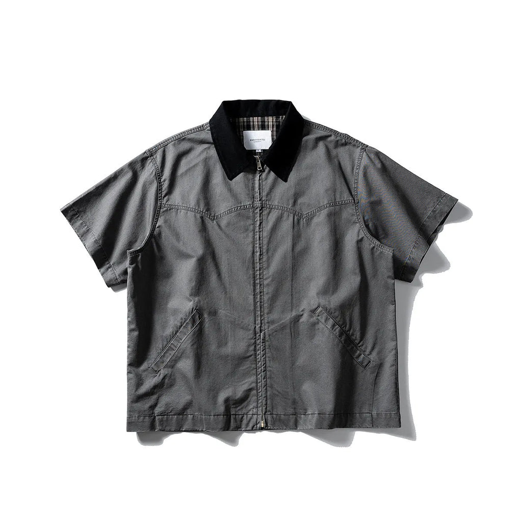Washed khaki loose-fit cotton overalls shirt with short sleeves on a hanger.