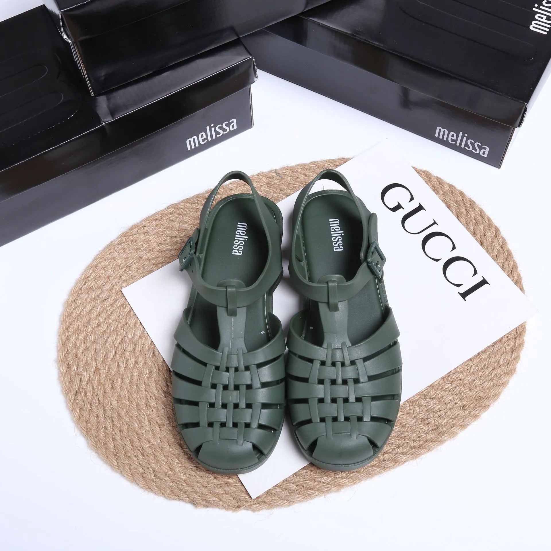Matte black Roman sandals with vintage weave pattern and buckle closure