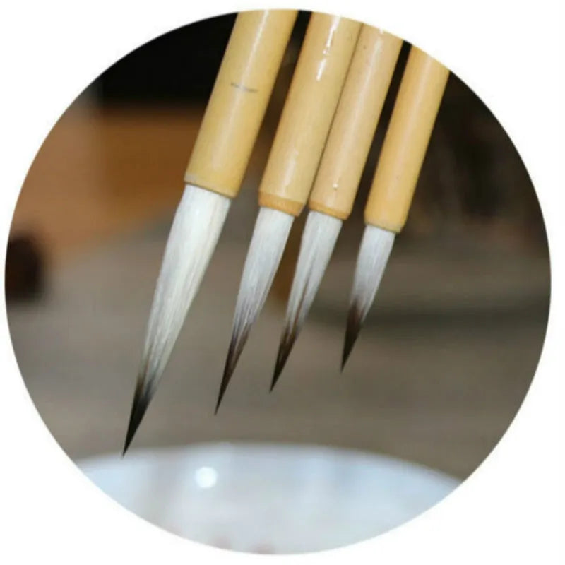 Four fine lower case writing brushes with thin gold body and mixed hair bristles in pine branch colour