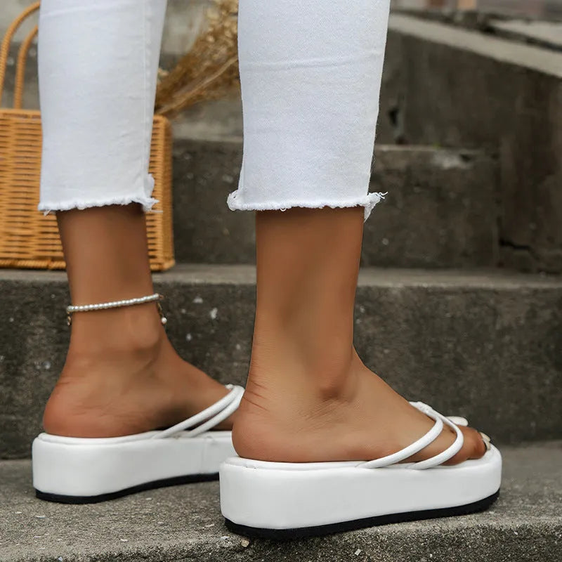 Women's thick sole flip-flops in multiple colours with herringbone pattern PU strap and rubber sole.