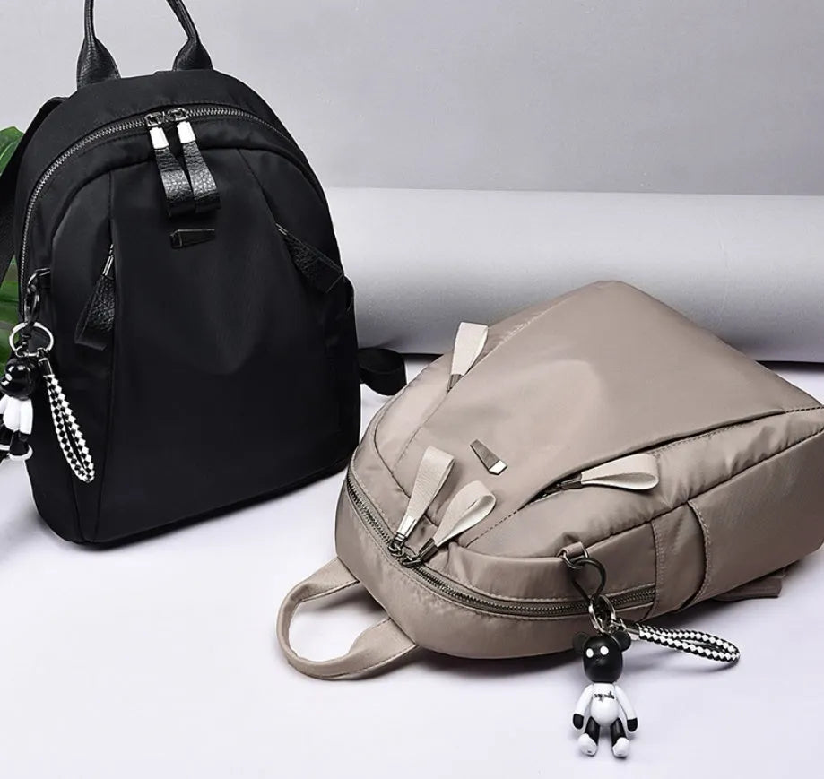 Medium wild fashion rucksack in Oxford cloth with vertical square shape, double straps, and zipper closure available in black, gray and wine red