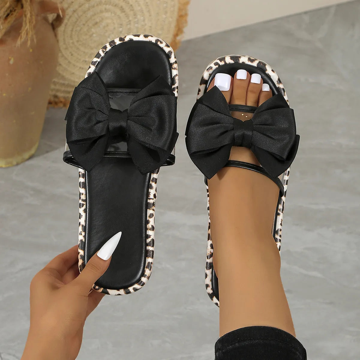 Leopard print women's slippers with thick sole and round toe in black or white.