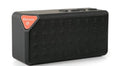 Cannon X3 small cube-shaped portable Bluetooth speaker in multiple colours on a table