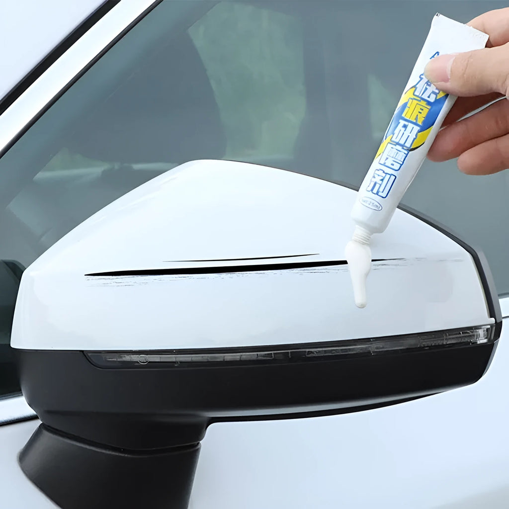 Automotive paint repair pen kit with touch-up fluid, scratch wax, sponge, and sandpaper.