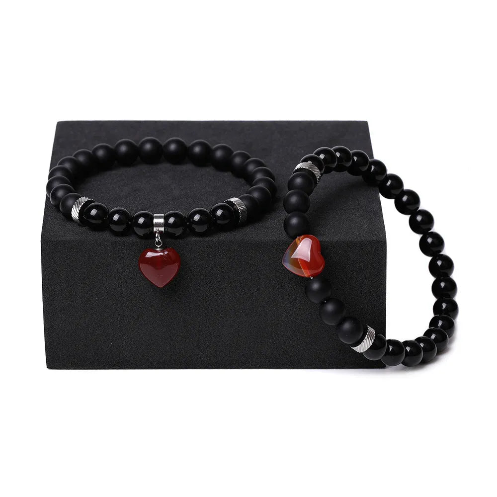 Natural stone couple bracelet set showing two matching bracelets with heart-shaped polished stone charms