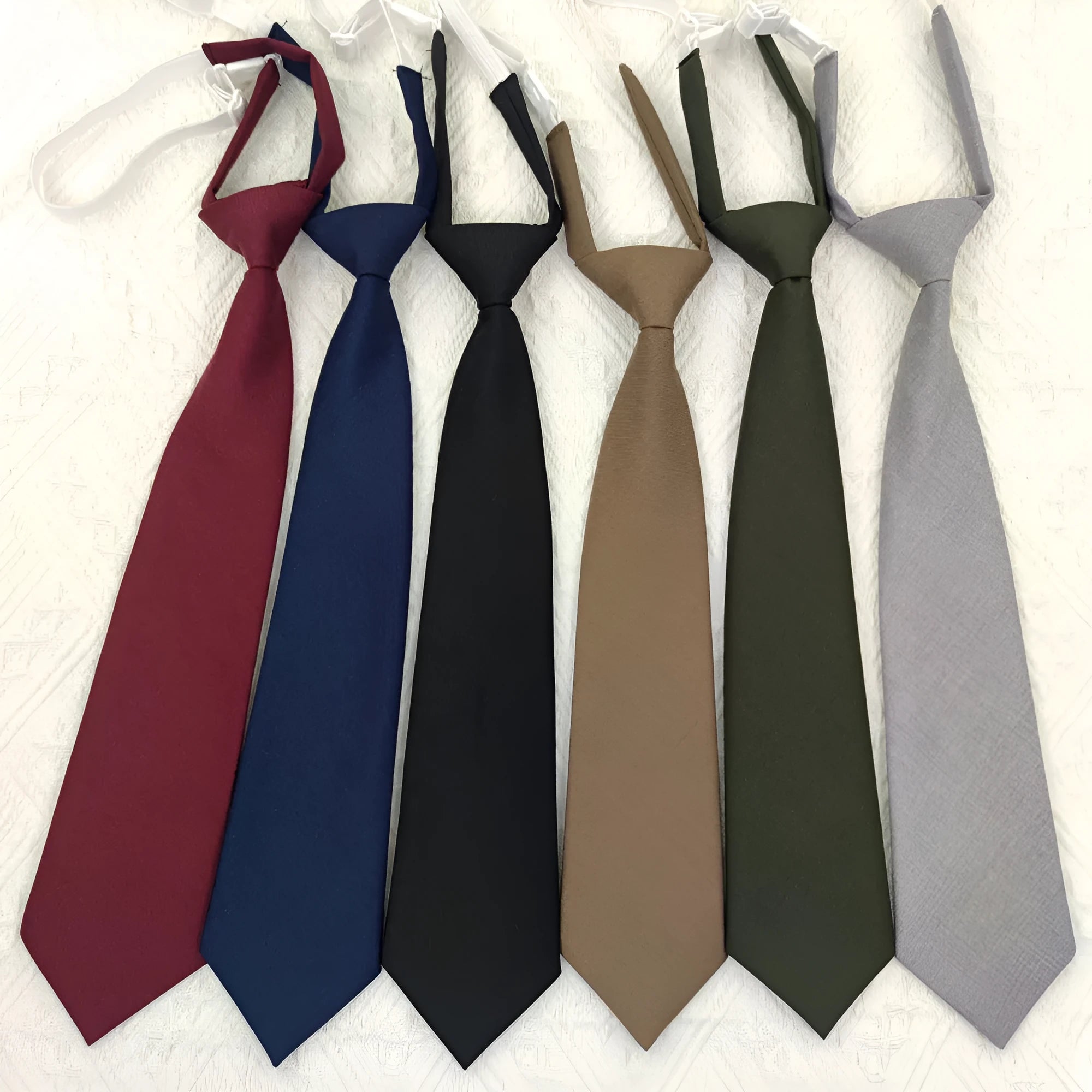 Solid navy blue men's cotton tie with arrow-type design on a white background.