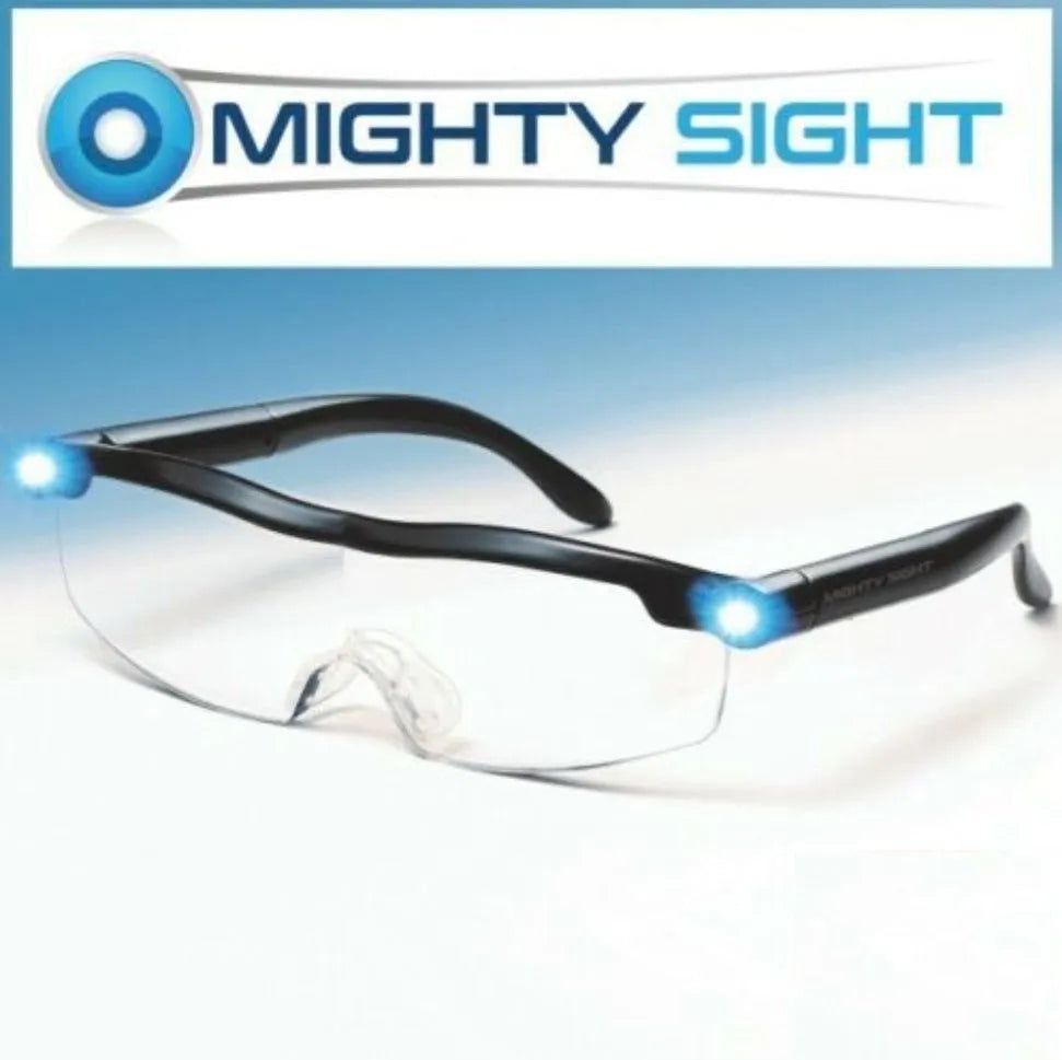 Transparent black USB LED light reading glasses on a table, showing the built-in light and frame.