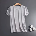 Man wearing a thin grey Ice Silk short sleeve crew neck t-shirt with a loose fit.