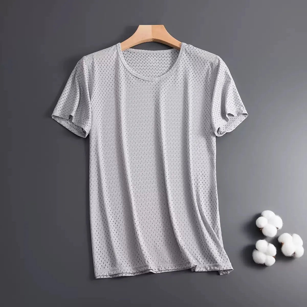 Man wearing a thin grey Ice Silk short sleeve crew neck t-shirt with a loose fit.