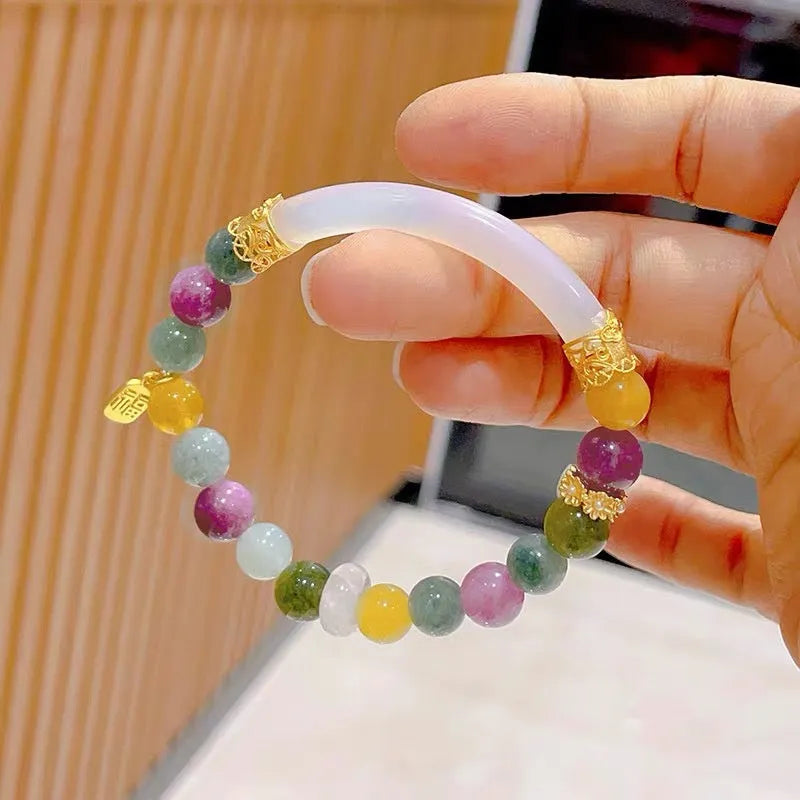 Rainbow coloured tourmaline half bracelet for women on a wrist, showing electroplated finish.