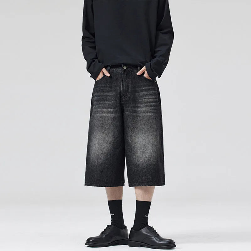 Man wearing straight-leg light blue denim shorts, showcasing the cropped length and loose casual fit.