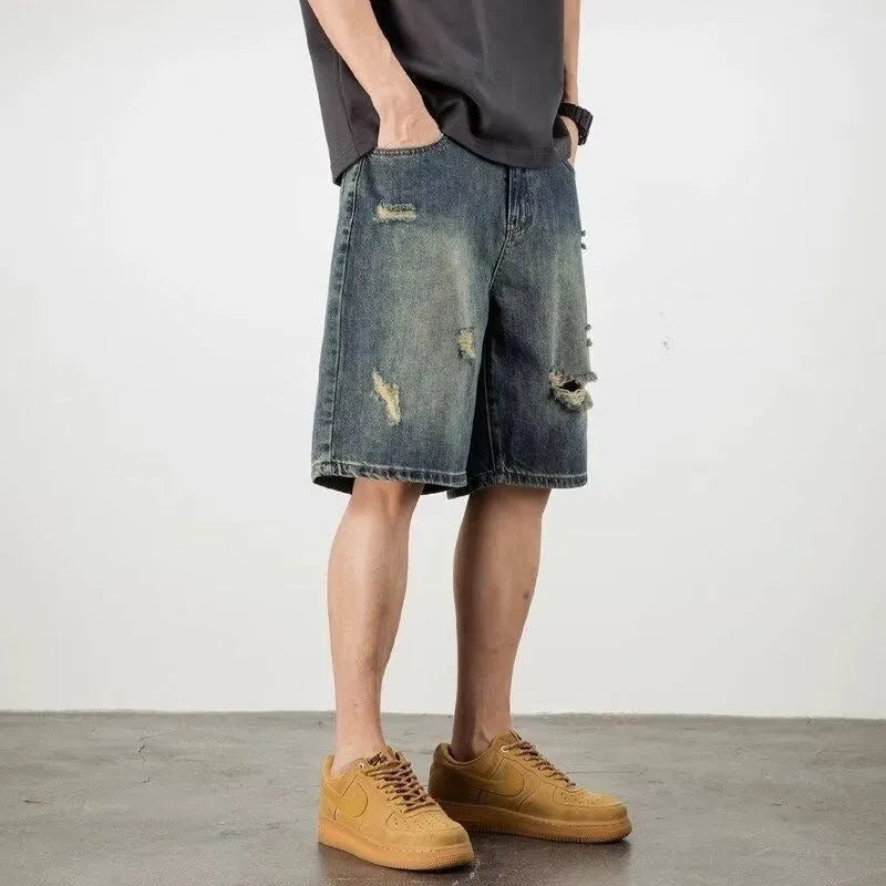Retro blue denim men's shorts with loose hole details and straight leg.