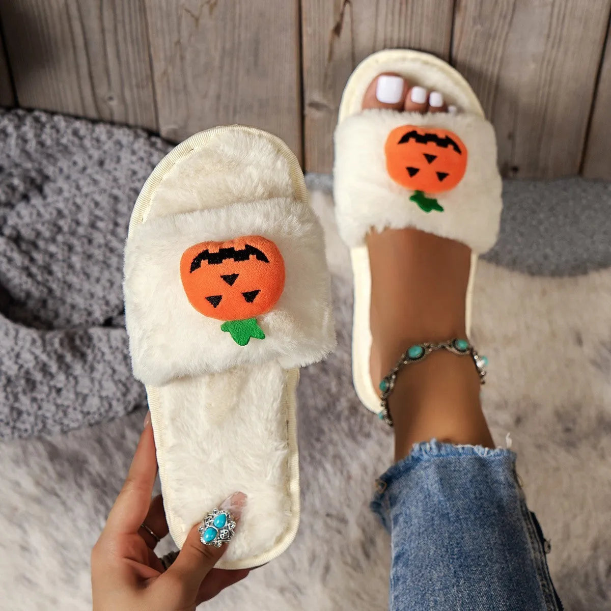 White and yellow Halloween pumpkin plush open toe slippers on anti-slip PVC sole.