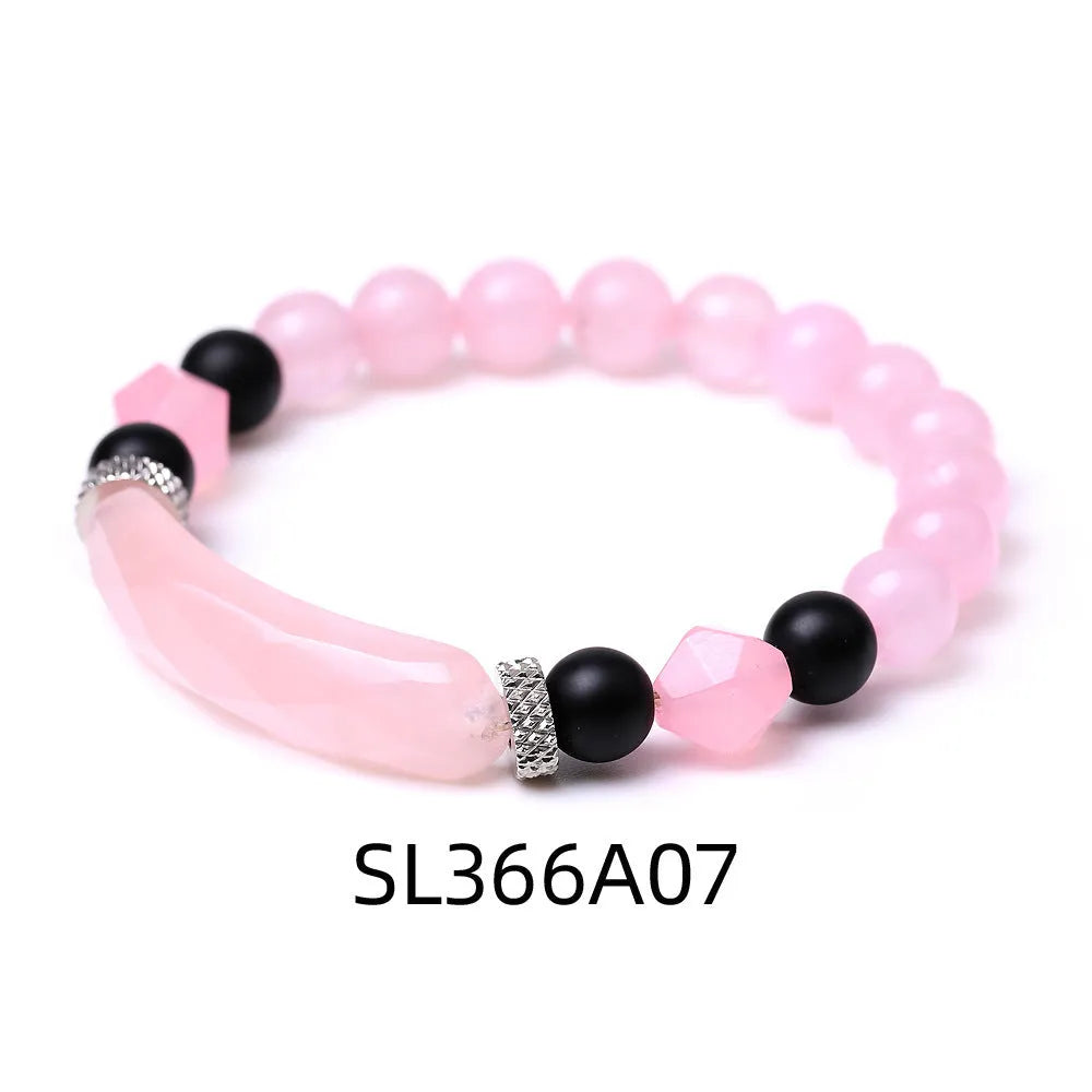 Handmade diamond-shaped cut agate bracelet in a geometric, fan-shaped design on a wrist.