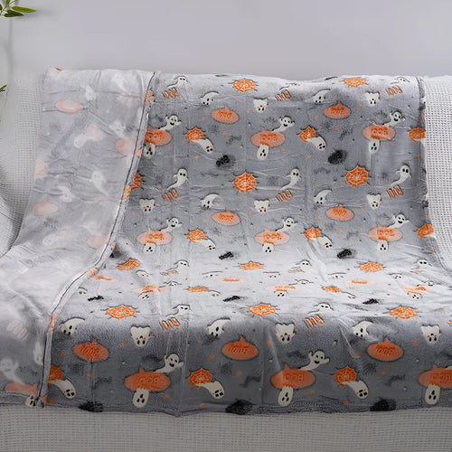 Children's cartoon flannel blanket in colourful design on bed
