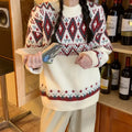 Red and white striped loose retro pullover knitted top on a hanger.