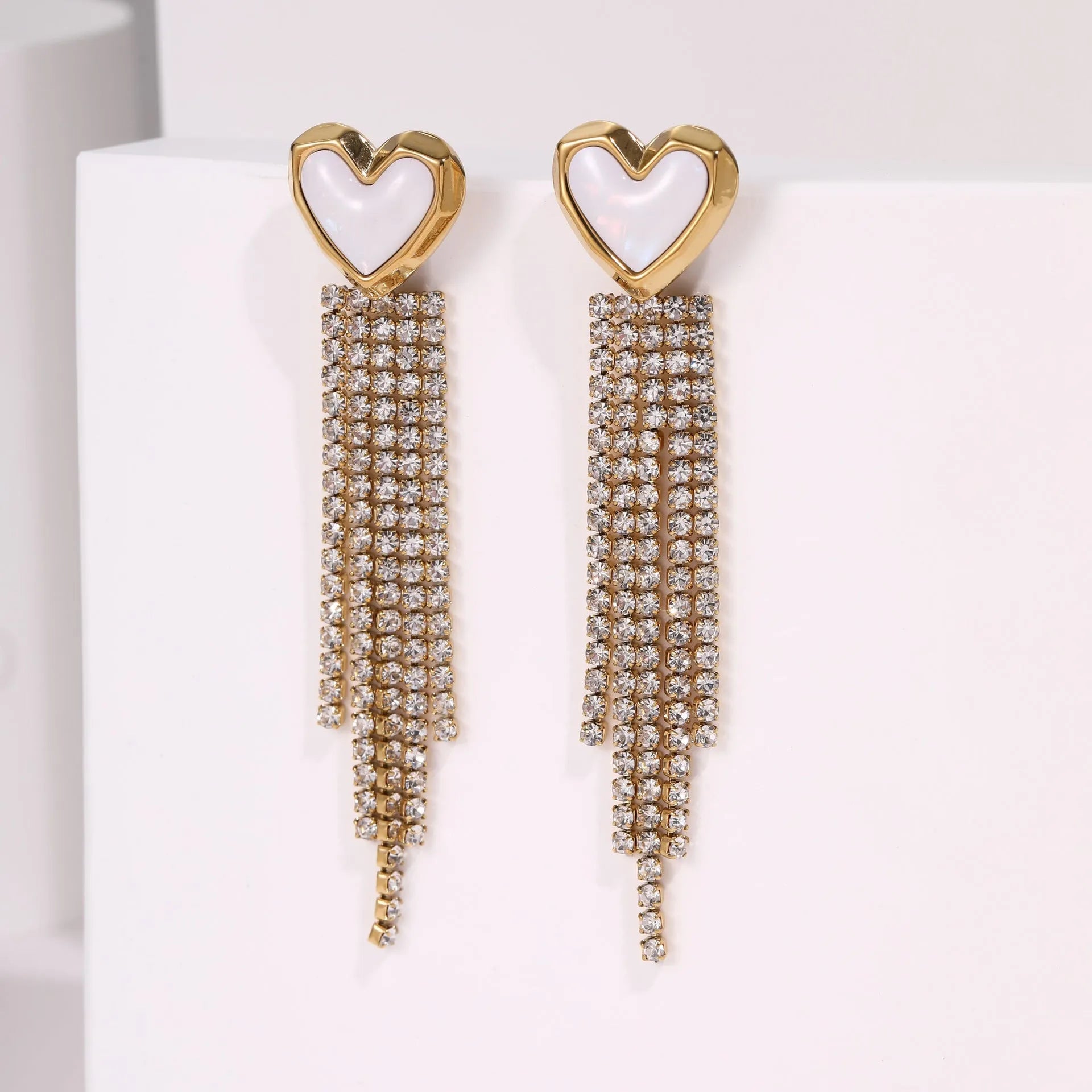 Stainless steel tassel earrings with 18K gold electroplated finish and diamond tips in heart and star shapes