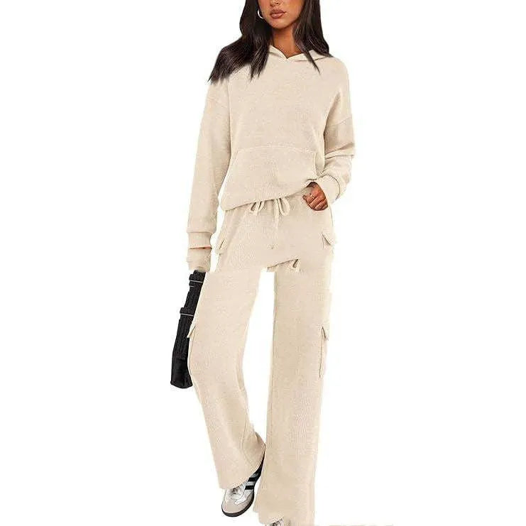 Women's two-piece leisure sports suit in polyester, showing long sleeve top and trousers in a solid colour.