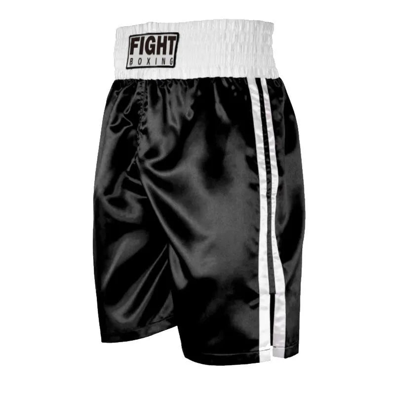 Man wearing black and white striped elastic waist kickboxing shorts in a training stance.