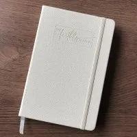 A5 hardcover note book with lined pages and black textured cover shown closed on a desk