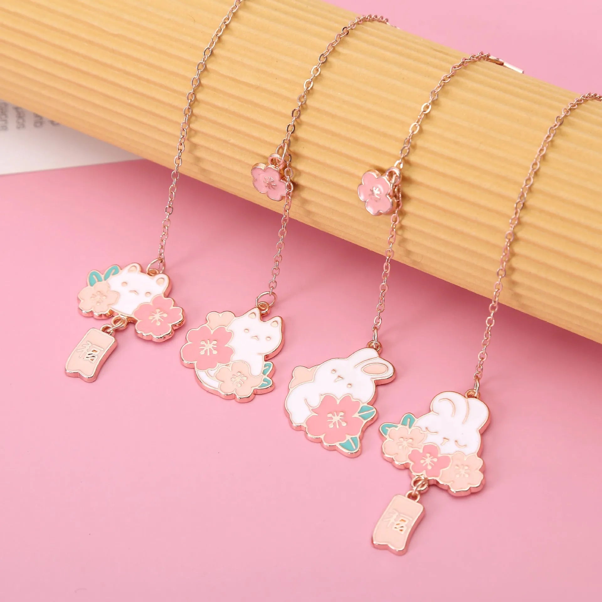Creative cartoon metal pendant bookmark featuring cherry blossom cat and rabbit designs.