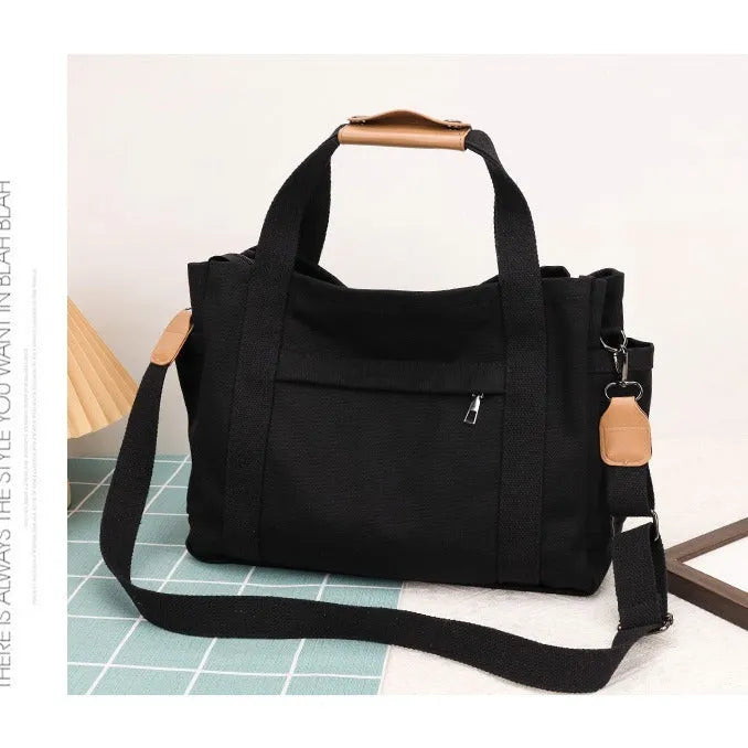 Canvas tote bag showing multiple internal compartments and both sides zipper openings in horizontal square shape