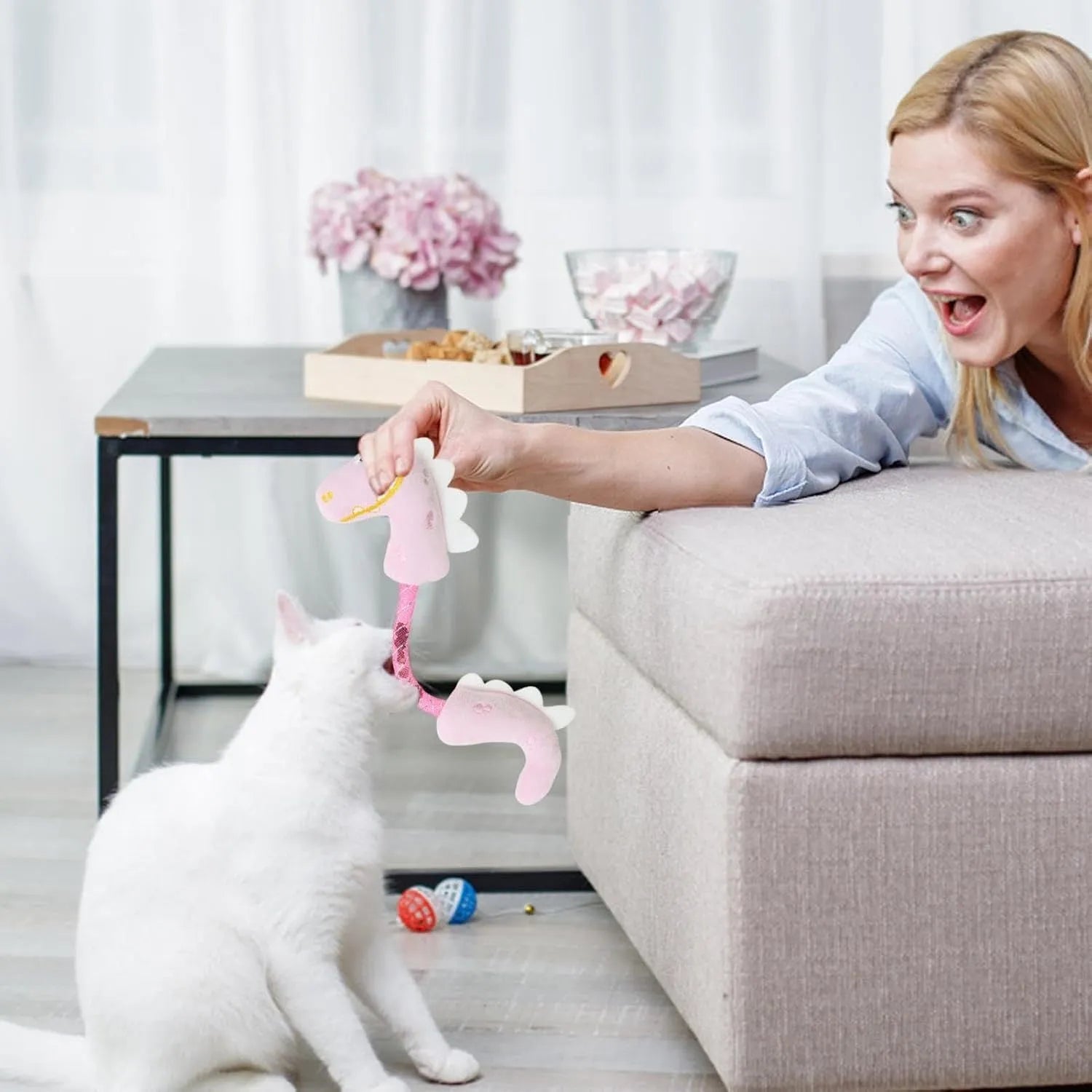 Set of four cat toys: plush fish, mouse, bunny, and a catnip rope on a plain background
