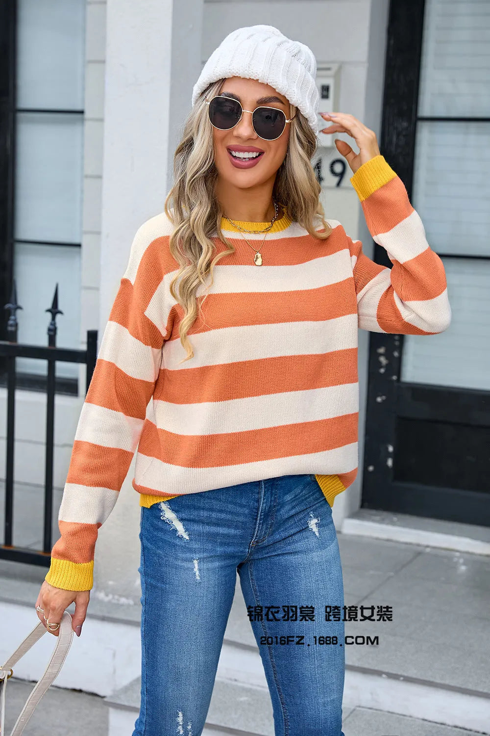 Women's loose long sleeve acrylic sweater in blue with stripes, round neck.