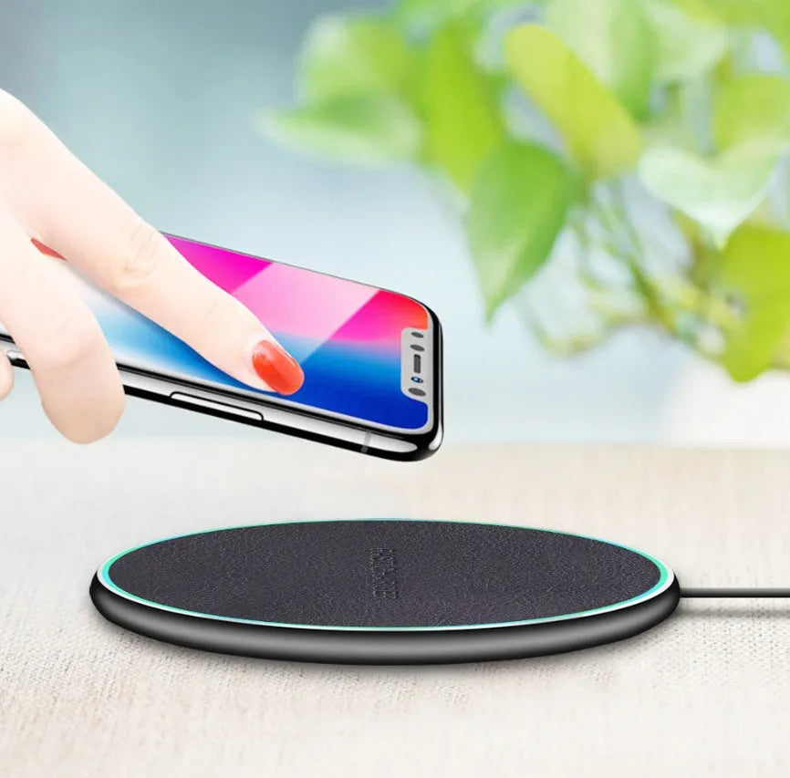 Black Qi wireless charging pad for iPhone 11 with soft silicone surface and LED indicator