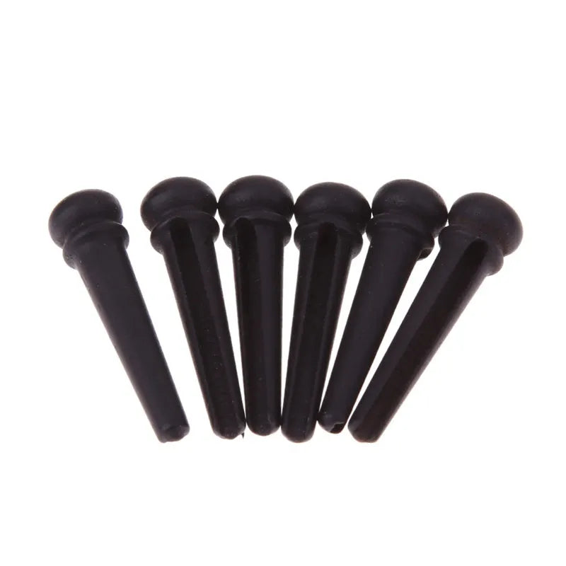 Six black matt ebony guitar bridge pins with solid string cone design