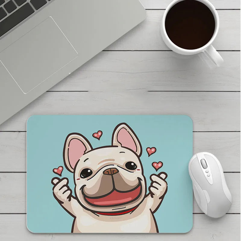 Custom cartoon design on a small black thickened mouse pad with stitching, shown on a desk.