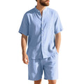 Man wearing a light blue short-sleeve linen blend suit jacket and matching shorts with a Henry collar.
